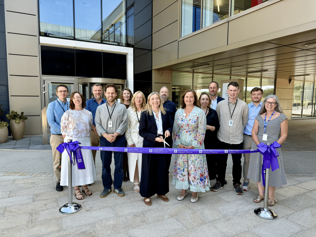 Dr Melanie Ivarsson cuts the ribbon outside the new HDRS offices at Wellcome Genome Campus